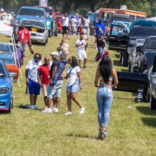 People wonder through the rows of cars during the Rick Ross Car and Bike Show in Fayetteville Saturday, June 3, 2023. (Steve Schaefer/steve.schaefer@ajc.com)
